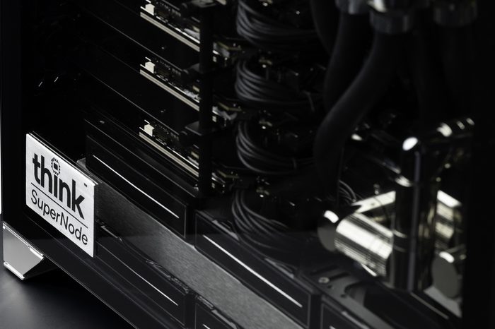 Close view of the SuperNode accelerator stack behind glass, with the think SuperNode badge